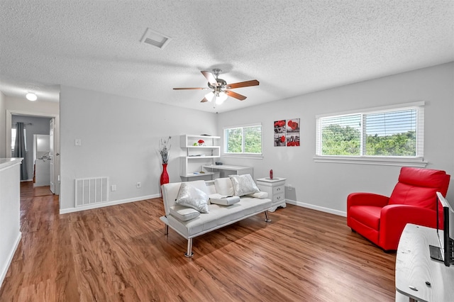 bedroom featuring a textured ceiling, hardwood / wood-style flooring, and ceiling fan