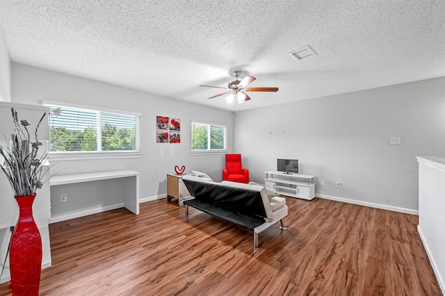 sitting room featuring hardwood / wood-style flooring, a textured ceiling, and ceiling fan