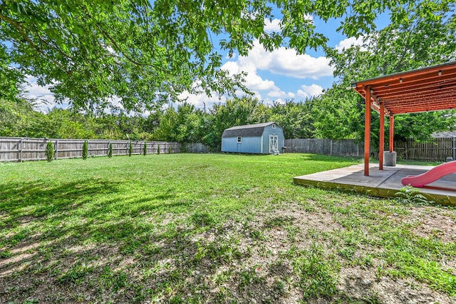 view of yard featuring a patio and a storage shed