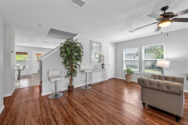 interior space with tile patterned flooring, ceiling fan, and a textured ceiling