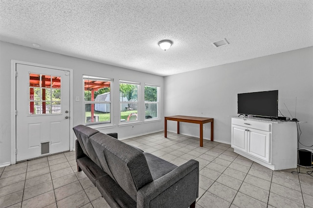 tiled living room with a textured ceiling