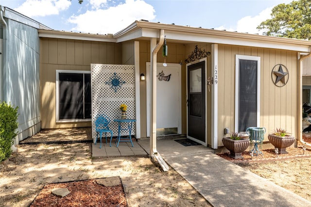 view of exterior entry featuring a patio area