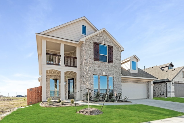 view of front facade with a balcony and a front lawn