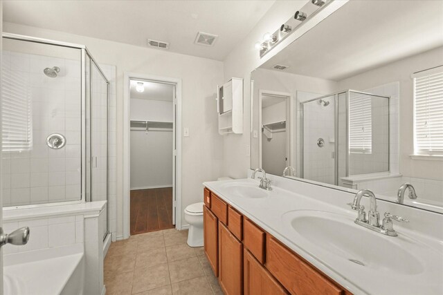 full bathroom featuring shower with separate bathtub, toilet, hardwood / wood-style floors, and double sink vanity