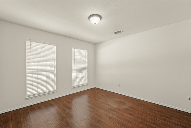 spare room with hardwood / wood-style floors