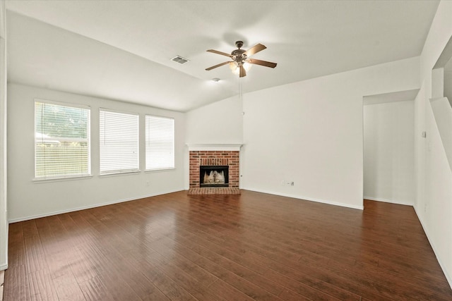 unfurnished living room with ceiling fan, a fireplace, lofted ceiling, and dark wood-type flooring