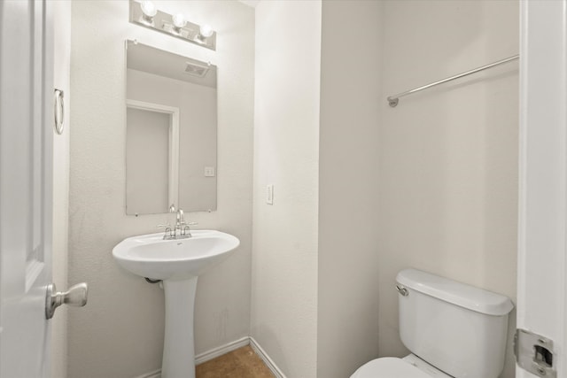 bathroom featuring toilet