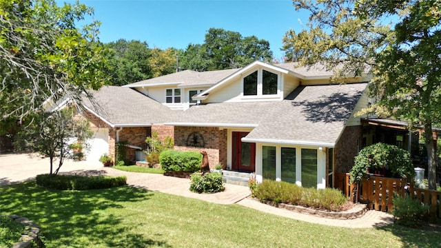 view of front of house with a garage and a front lawn