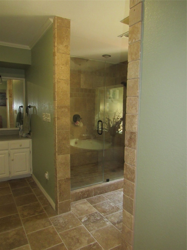 bathroom with vanity, a shower with shower door, and crown molding