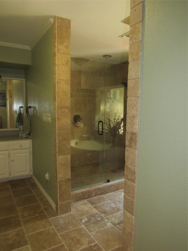 bathroom featuring ornamental molding, a stall shower, vanity, and stone tile floors