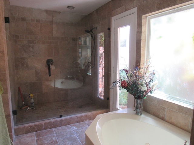 bathroom featuring shower with separate bathtub