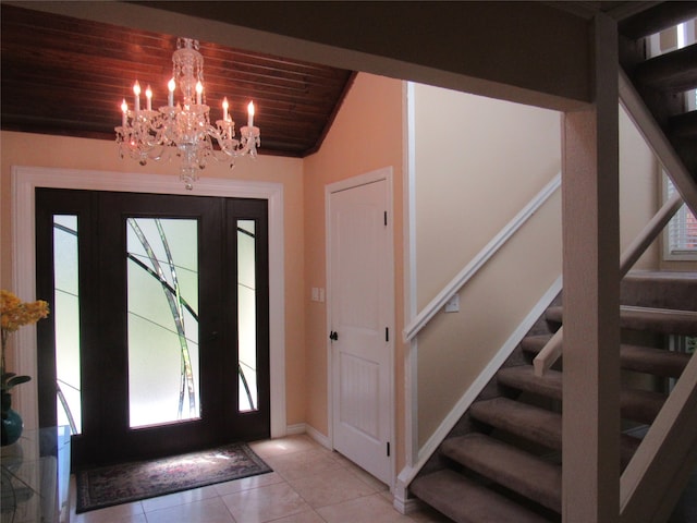 tiled entryway featuring wood ceiling, a chandelier, and lofted ceiling