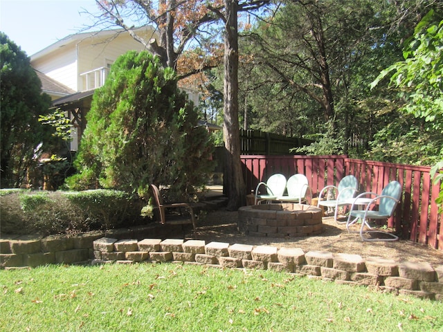 view of yard with a fire pit