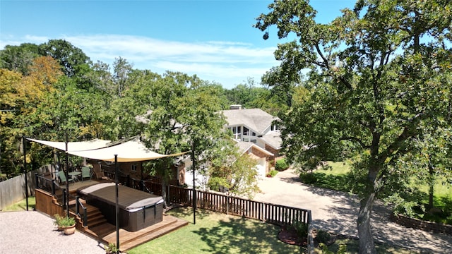 view of yard with a wooden deck and a hot tub