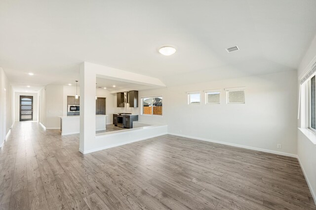 unfurnished living room with wood-type flooring