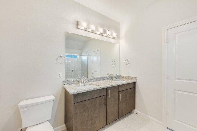 bathroom featuring an enclosed shower, vanity, and toilet