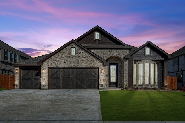 view of front of house with a garage and a lawn