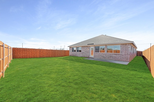 rear view of property with a lawn