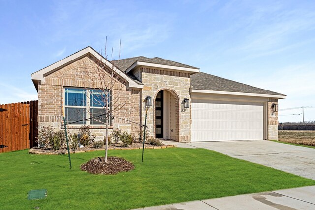 view of front of property featuring a garage and a front yard