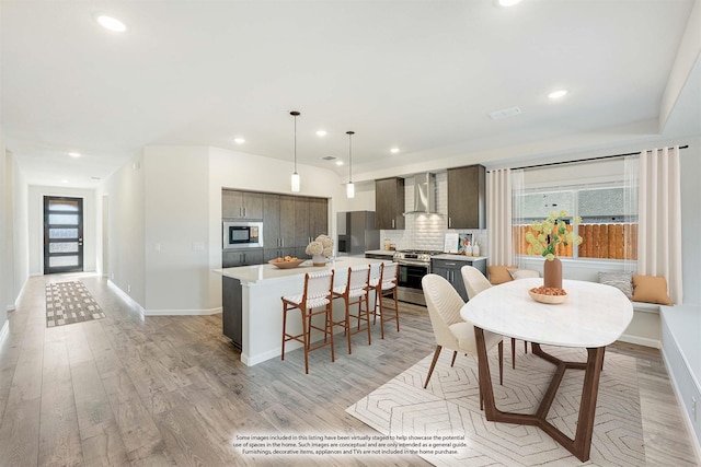 dining space featuring a healthy amount of sunlight and light hardwood / wood-style flooring