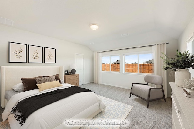 bedroom with vaulted ceiling and light colored carpet