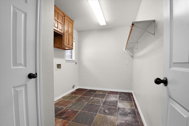 washroom with washer hookup and a textured ceiling