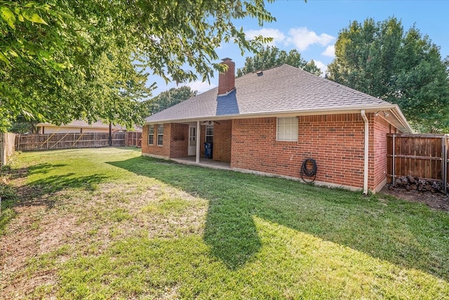 back of house featuring a patio and a lawn