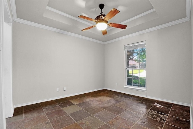 empty room with crown molding, ceiling fan, and a tray ceiling