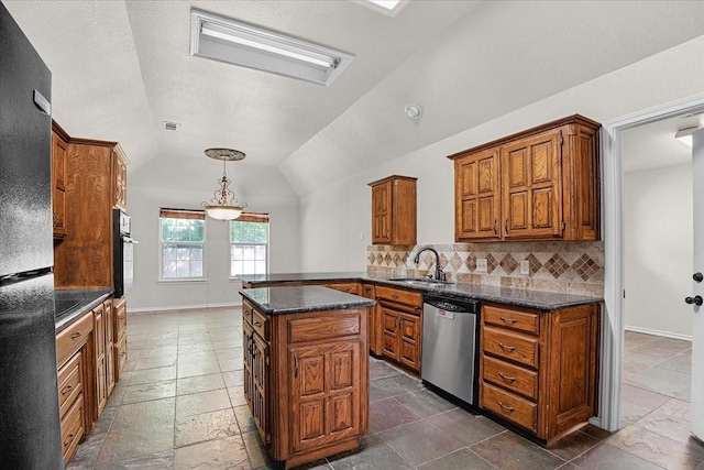 kitchen featuring lofted ceiling, sink, black appliances, a kitchen island, and backsplash