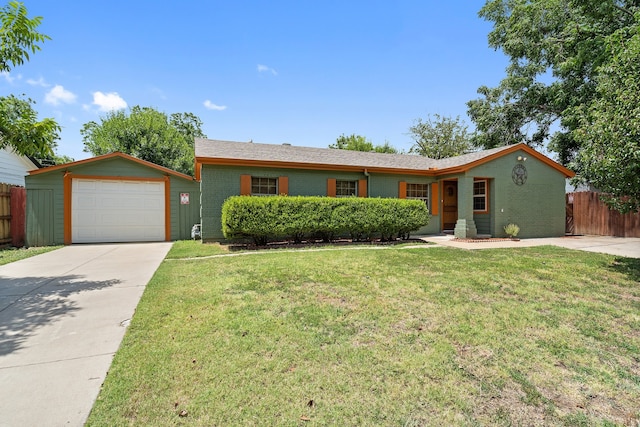 ranch-style home featuring a garage and a front lawn