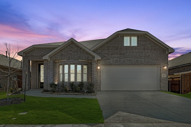 view of front facade with a yard and a garage