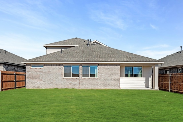 back of house featuring a lawn