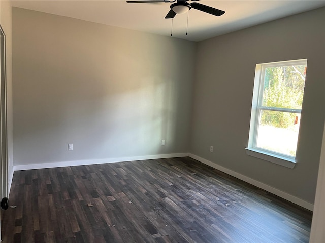 unfurnished room featuring dark wood-type flooring and ceiling fan