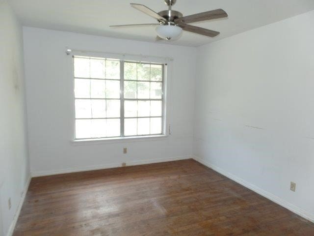 spare room with ceiling fan and hardwood / wood-style flooring