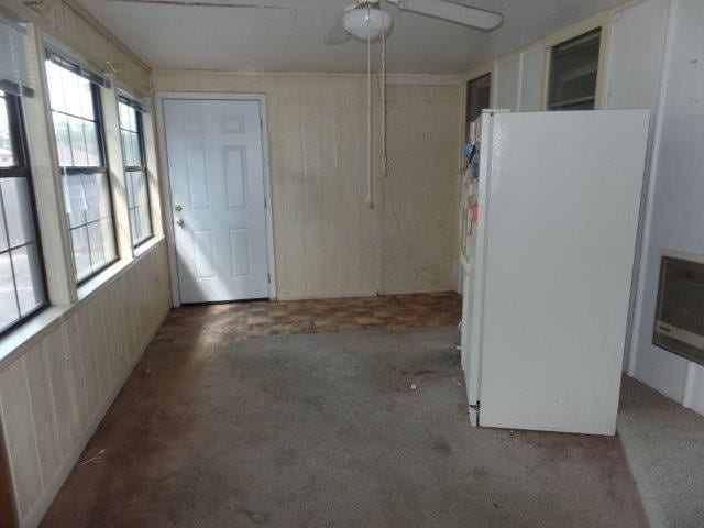 kitchen with light colored carpet, plenty of natural light, ceiling fan, and white fridge