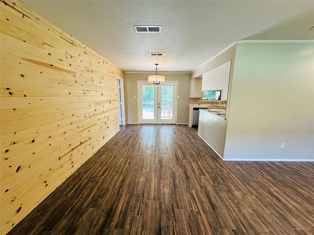 interior space featuring crown molding, french doors, wood walls, dark hardwood / wood-style flooring, and sink