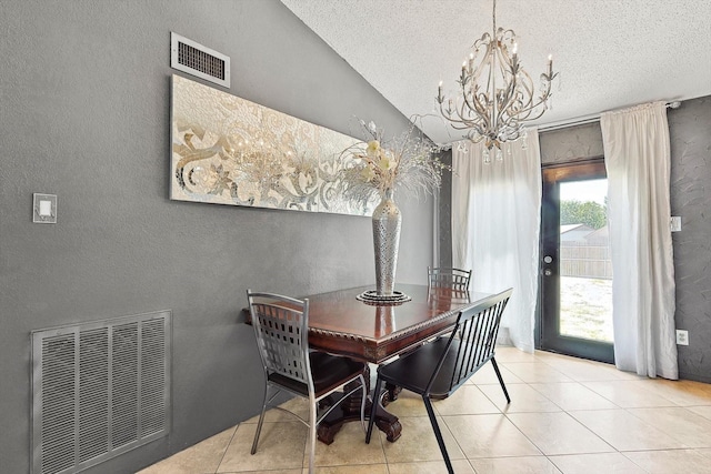 tiled dining space featuring a textured ceiling, lofted ceiling, and a notable chandelier