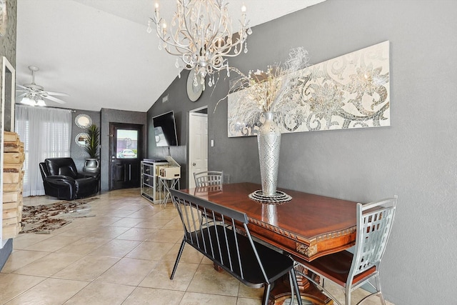 tiled dining room with lofted ceiling and ceiling fan with notable chandelier