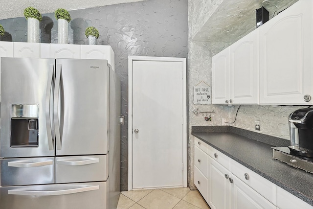 kitchen with white cabinetry, light tile patterned floors, and stainless steel fridge with ice dispenser