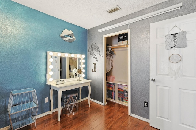 interior space with a closet, dark hardwood / wood-style flooring, and a textured ceiling