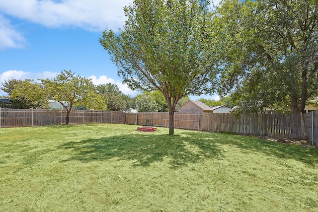 view of yard with a fire pit