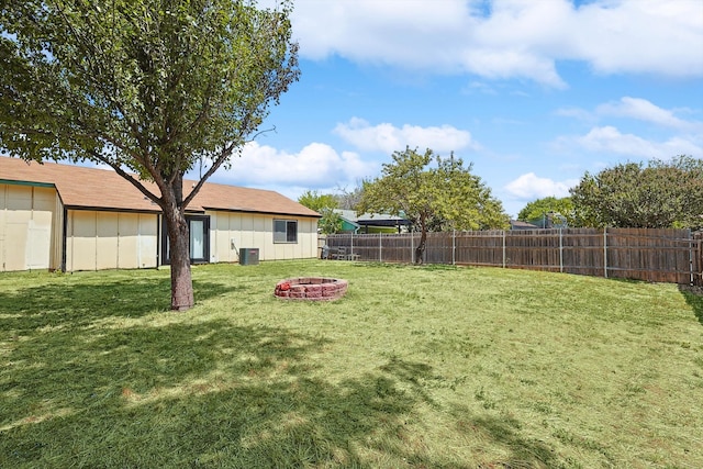 view of yard with an outdoor fire pit and central AC