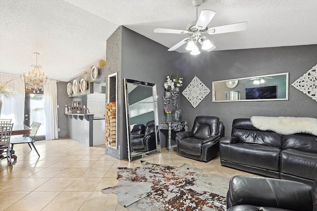 living room featuring ceiling fan with notable chandelier, a textured ceiling, light tile patterned floors, and lofted ceiling