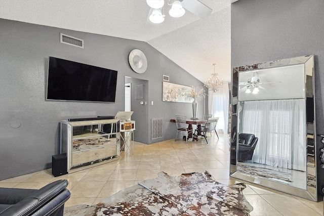 living room featuring vaulted ceiling, light tile patterned floors, and ceiling fan with notable chandelier