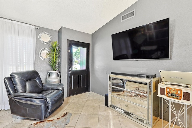 tiled foyer entrance featuring vaulted ceiling