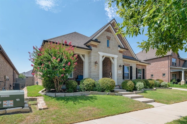 view of front of property featuring a front yard and central air condition unit