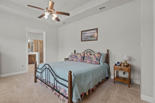 bedroom featuring ensuite bath, ceiling fan, and light carpet