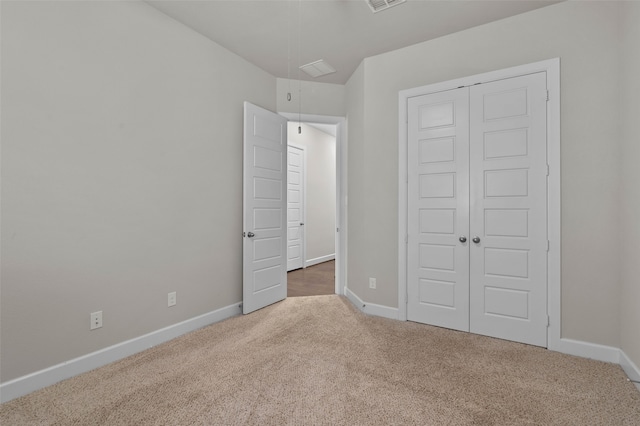 unfurnished bedroom with a closet and dark carpet