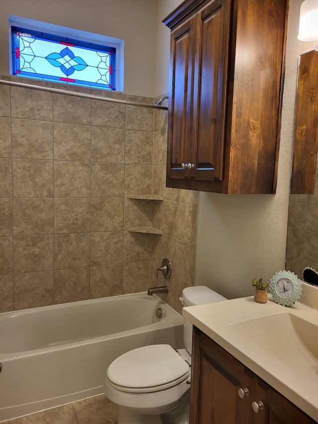 full bathroom with tile patterned flooring, vanity, toilet, and tiled shower / bath