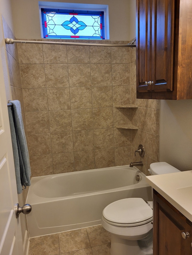 full bathroom featuring vanity, toilet, tile patterned flooring, and tiled shower / bath combo